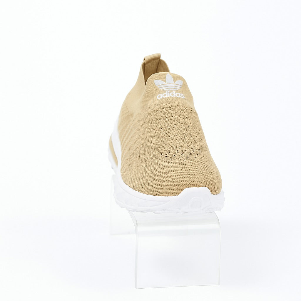 beige Adidas slip-on shoes with a white sole. 36883